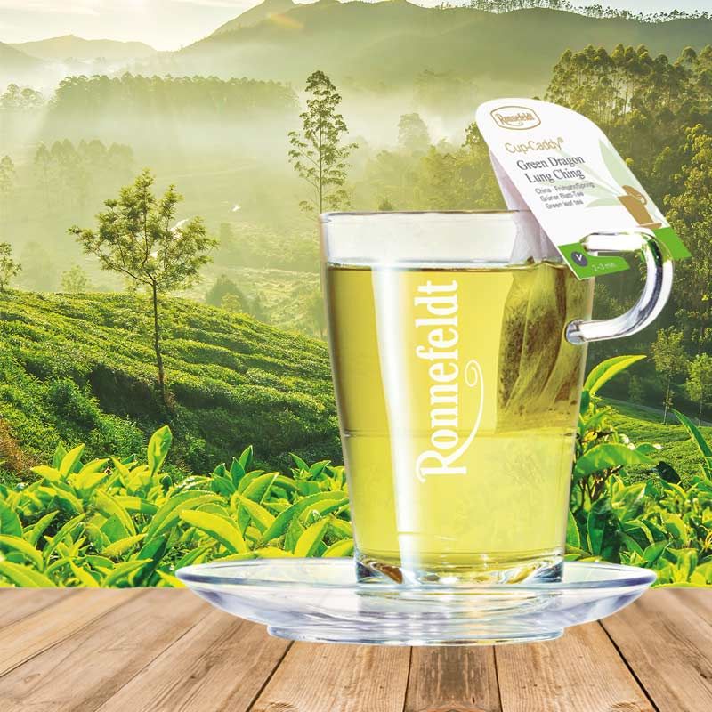 Ronnefeldt CupCaddy® Green Dragon Lung Ching – a vibrant green tea enjoyed amidst lush tea gardens.